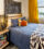 Bed with blue sheets and hanging decor